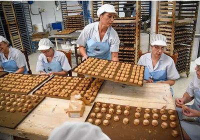 Bakery workers laying mantecados out on trays at La Colchona in Estepa