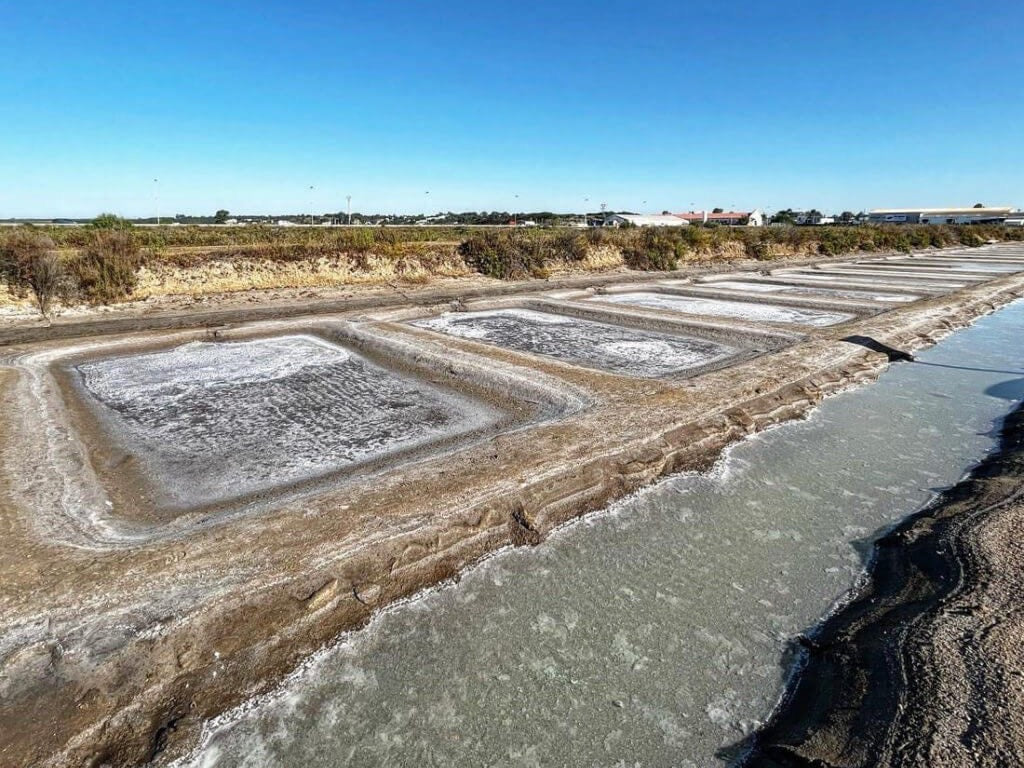 The crystallising ponds at Salinas del Alemán, Isla Cristina, Huelva, under a clear blue sky
