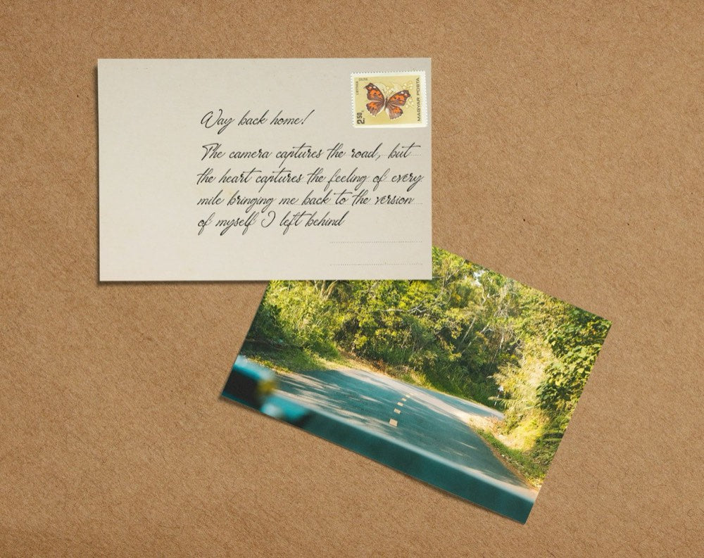 Two postcards on kraft paper: a handwritten note with a butterfly stamp and a photo of a country road